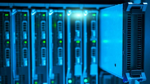 A hard drive being pulled out of a server rack