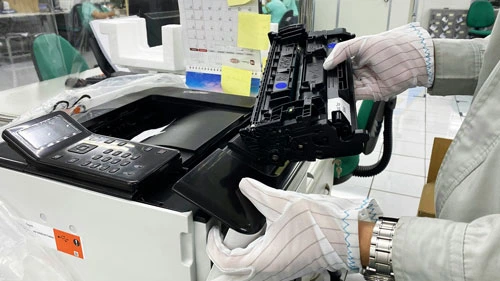 Technician removing laser printer drum