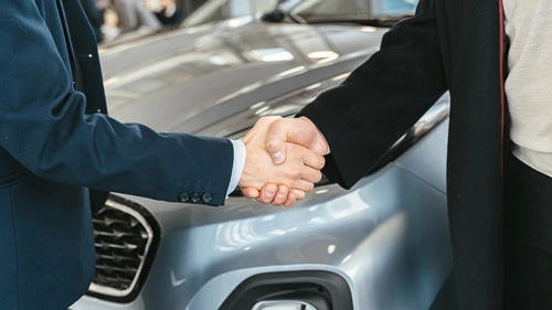 Two people shaking hands at a business location